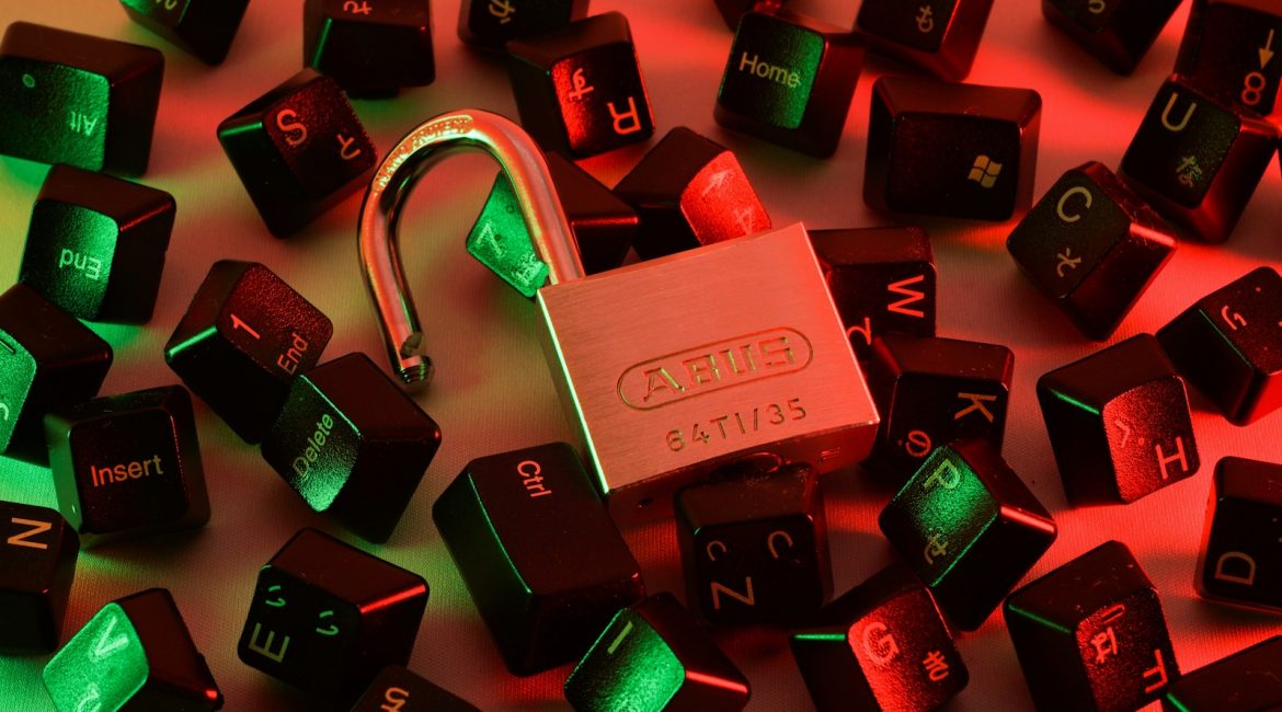 Physical security lock on keyboard keys with red and green cybersecurity illumination representing bare-metal network firewall architecture