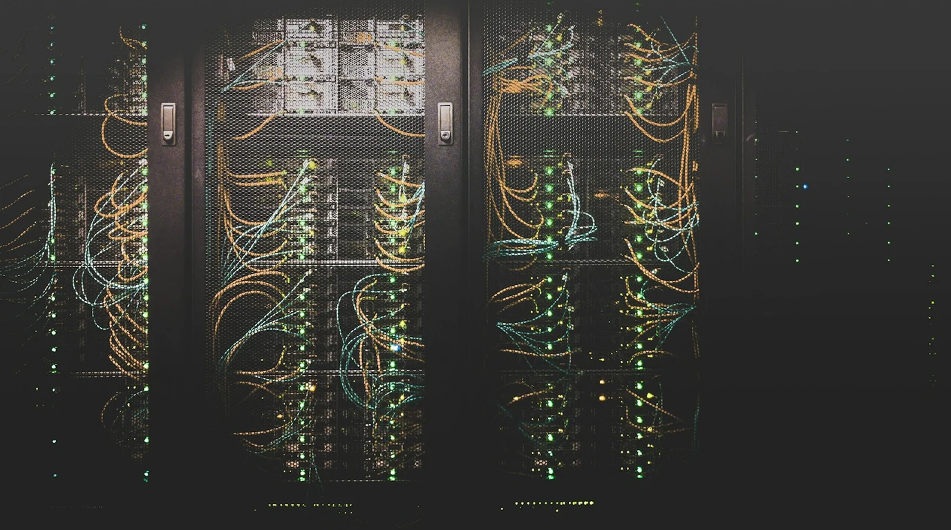 High-density enterprise server blades illuminated by server rack LEDs running containerized microservices and virtualized workloads