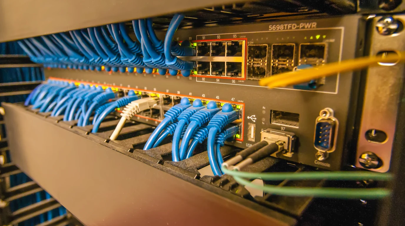 Enterprise server rack showing dual redundant bare-metal OPNsense firewall nodes wired with high-speed pfsync synchronization links